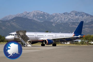commercial aircraft at an airport, with mountainous background - with Alaska icon