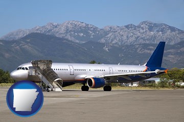 commercial aircraft at an airport, with mountainous background - with Arkansas icon