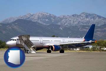 commercial aircraft at an airport, with mountainous background - with Arizona icon