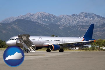 commercial aircraft at an airport, with mountainous background - with Kentucky icon