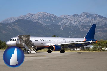 commercial aircraft at an airport, with mountainous background - with New Hampshire icon