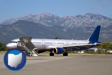commercial aircraft at an airport, with mountainous background - with Ohio icon
