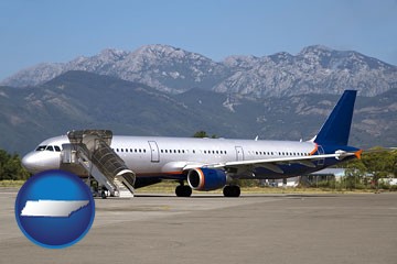 commercial aircraft at an airport, with mountainous background - with Tennessee icon