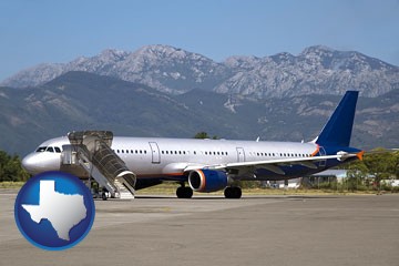 commercial aircraft at an airport, with mountainous background - with Texas icon