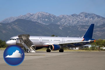 commercial aircraft at an airport, with mountainous background - with Virginia icon