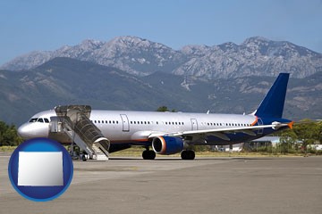 commercial aircraft at an airport, with mountainous background - with Wyoming icon