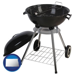 a kettle-style charcoal grill - with North Dakota icon