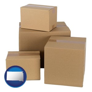 a stack of cardboard boxes - with South Dakota icon