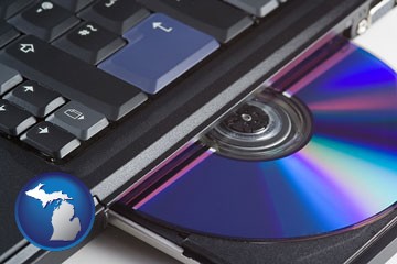 loading software into a laptop computer from a cd - with Michigan icon