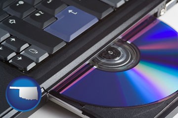 loading software into a laptop computer from a cd - with Oklahoma icon
