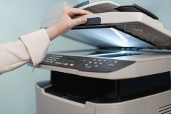 a woman using a photocopier