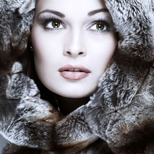 a young woman wearing a fur coat and hood
