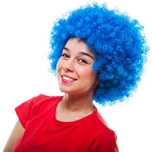 a smiling girl wearing a curly blue wig