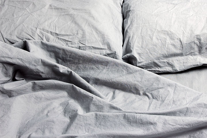 rumpled gray pillows and sheets on a bed (large image)