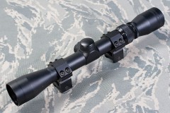 a rifle scope on camouflage background