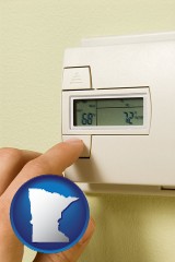 minnesota map icon and a heating system thermostat