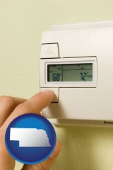 nebraska map icon and a heating system thermostat