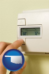 oklahoma map icon and a heating system thermostat