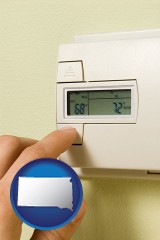 south-dakota map icon and a heating system thermostat