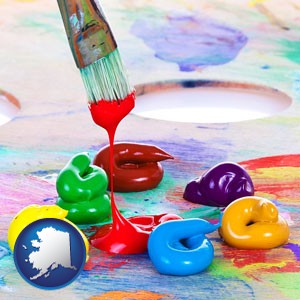 colorful oil paints and paintbrush - with Alaska icon