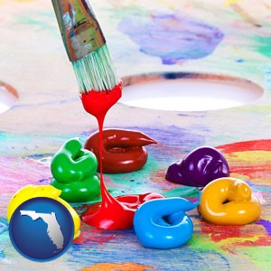 colorful oil paints and paintbrush - with Florida icon