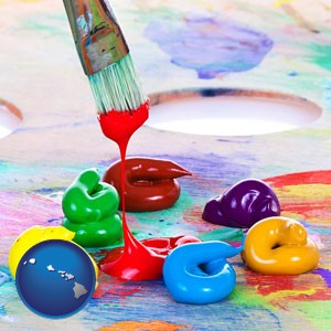 colorful oil paints and paintbrush - with Hawaii icon