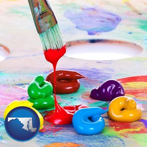 colorful oil paints and paintbrush - with Maryland icon
