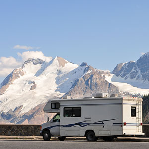 a recreational camper vehicle with mountain glacier background