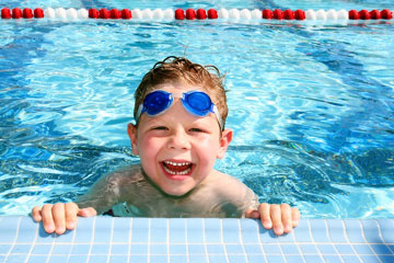 a boy in a swimming pool