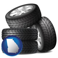 georgia map icon and four tires with alloy wheels