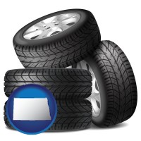 north-dakota map icon and four tires with alloy wheels
