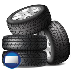 four tires with alloy wheels - with South Dakota icon