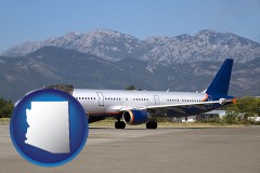 arizona map icon and commercial aircraft at an airport, with mountainous background