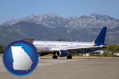 georgia map icon and commercial aircraft at an airport, with mountainous background