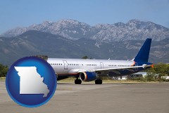 missouri map icon and commercial aircraft at an airport, with mountainous background