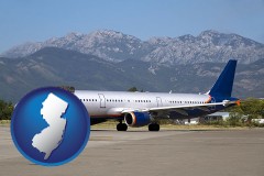 new-jersey map icon and commercial aircraft at an airport, with mountainous background
