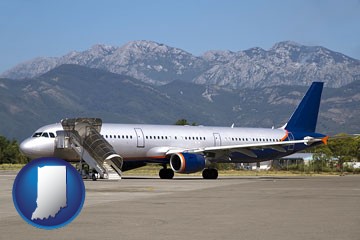 commercial aircraft at an airport, with mountainous background - with Indiana icon