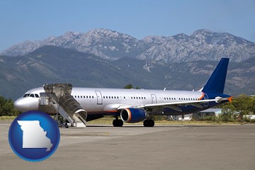 commercial aircraft at an airport, with mountainous background - with Missouri icon