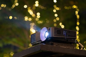 a black projector in an auditorium