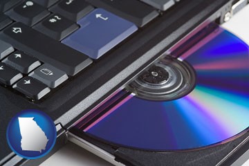 loading software into a laptop computer from a cd - with Georgia icon