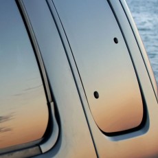 a sunset reflected in tinted glass car windows