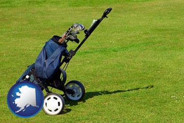 a golf bag on a green fairway - with Alaska icon