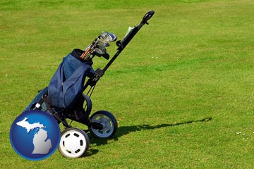 a golf bag on a green fairway - with Michigan icon