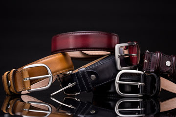 a stack of leather belts