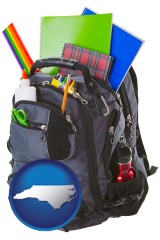 north-carolina map icon and a backpack filled with school supplies